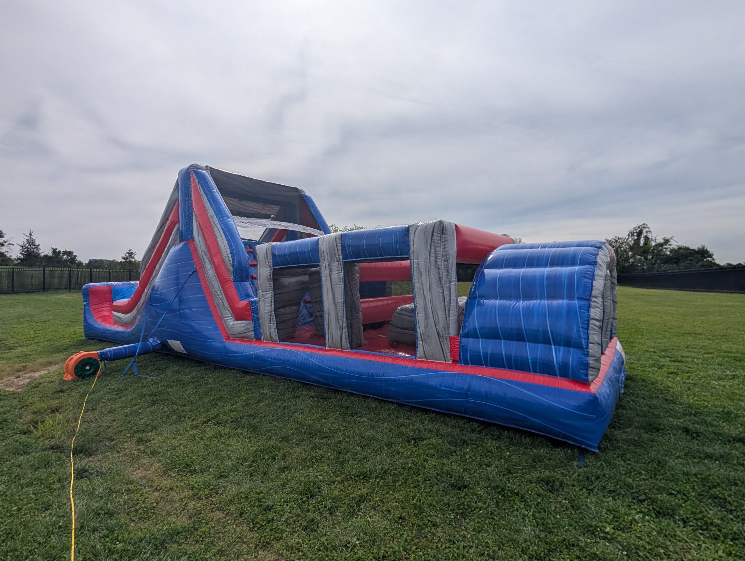 Wide inflatable obstacle course on the grass at Walnut Grove Elementary in Bargersville