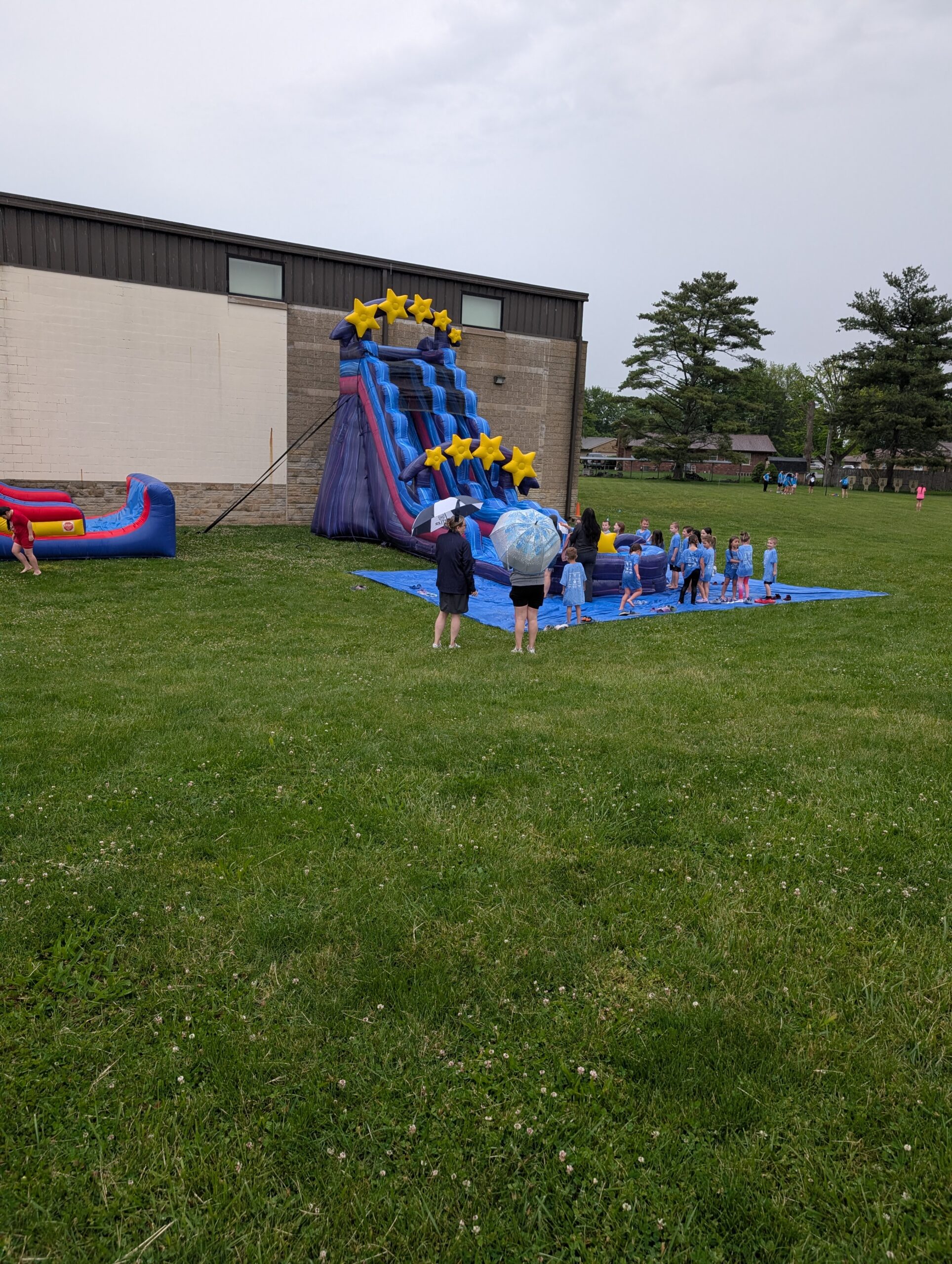 Star-themed waterslide with event attendees in Franklin