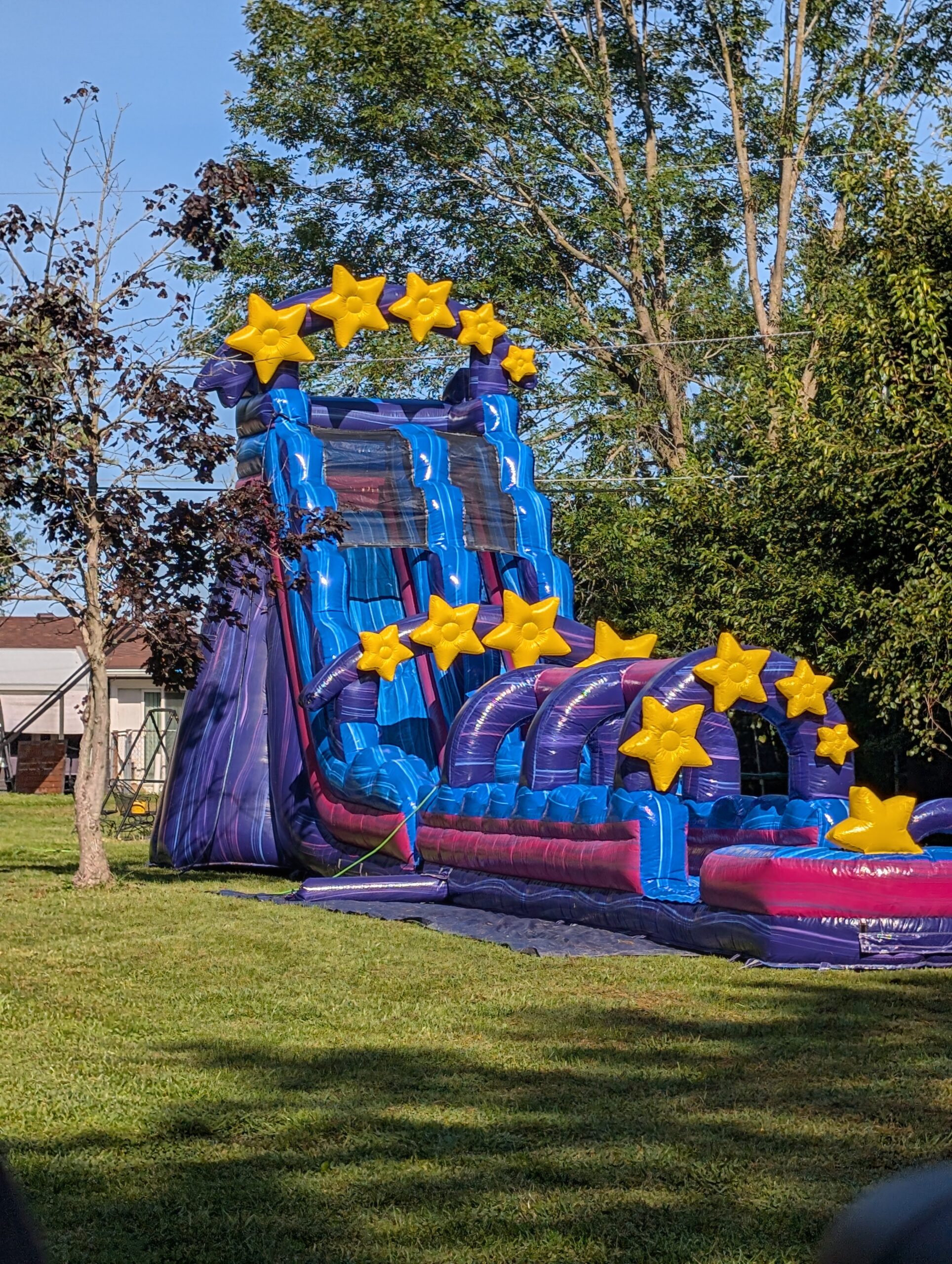 Star-themed waterslide on a lawn in an Indianapolis backyard